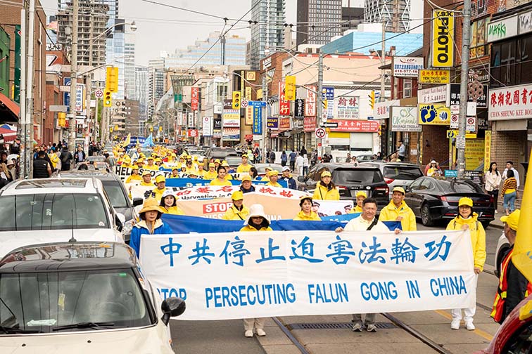 多伦多法轮功学员举行了庆祝世界法轮大法日大游行，队伍穿过了市中心多个热门景点。（图片来源：明慧网）