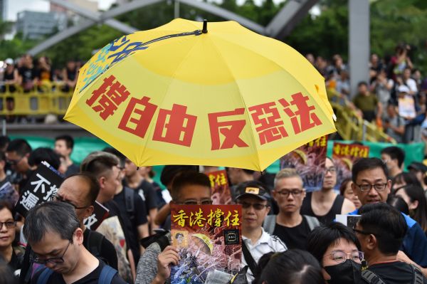 7月7日，23万香港人参加了九龙“反送中”游行，游行人士手持《看中国》印刷的“香港撑住”画报。