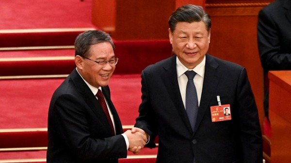 3月11日，习近平和李强在中共全国人大会议上。(图片来源：Greg Baker/POOL/AFP)