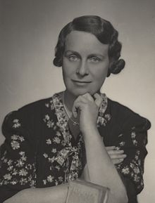 Black and white portrait photograph of Haslett taken about 1924. She is looking into the camera, wearing a dress and resting her chin on her hand. Electrical Association for Women