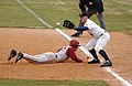 Image 23A first baseman receives a pickoff throw, as the runner dives back to first base. (from Baseball)