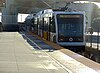 A westbound train at Harbor Freeway station