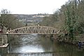 Most of the development on one side of the valley – footbridge over the River Derwent