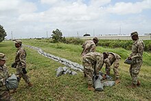 Louisiana National Guard placing sandbags along a levee in Louisiana