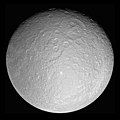 Image 2 Rhea Photo credit: Cassini orbiter Rhea, at 1,528 kilometres (949 mi) across, is the second-largest moon of Saturn and the ninth largest moon in the Solar System. It was discovered in 1672 by Giovanni Domenico Cassini, who named it after the Titan Rhea of Greek mythology, "mother of the gods". The giant Tirawa impact basin is seen above and to the right of center. Tirawa, and another basin to its southwest, are both covered in impact craters, indicating they are quite ancient. More selected pictures