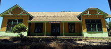 A low wooden building with large windows