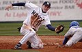 Image 43A shortstop tries to tag out a runner who is sliding head first, attempting to reach second base. (from Baseball)