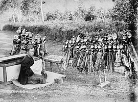 A dalang (puppeteer) in a wayang golek (wooden puppet) performance, between 1880 and 1910