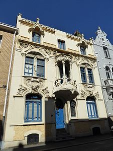 Mix of Art Nouveau and Gothic Revival – Rue Gustave-Lemaire no. 51 in Dunkerque, France, with pointed arched-dormer windows and balcony loggia, unknown architect, decorated with sculptures by Maurice Ringot (1903–1910)[177]