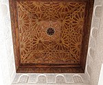 Example of carved cedar wood ceiling with geometric star patterns (over the madrasa's vestibule)