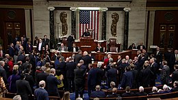 Nancy Pelosi presides over a crowded House of Representatives chamber floor during the impeachment vote