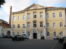 Queen Leonor Spring Water Hospital, or Thermal Hospital. Three story yellow façade.