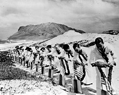 Seamen at Kaneohe Naval Air Station decorate the graves of their fellow neutral sailors killed at Pearl Harbor