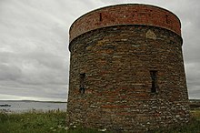 A photograph of a circular stone building