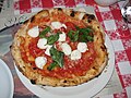 Image 53Traditional pizza Margherita, whose ingredients, tomato (red), mozzarella (white) and basil (green), are inspired by the colours of the national flag of Italy. (from Culture of Italy)