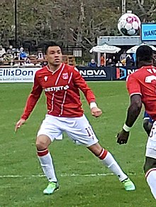 Escalante preparing to head a ball flying above his head during play