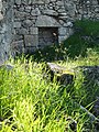 What remains of the inside wall of a house, with niche in wall