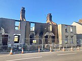 Burned-out houses after the Wennington wildfire