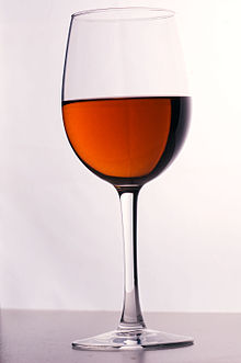 Verre contenant un liquide rouge orangé.