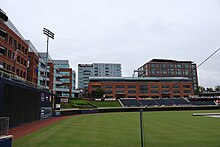 Amid other development, a three-story office building bordering a baseball stadium.