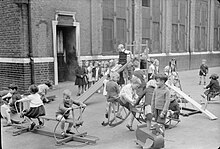 Children playing with toys and playground equipment.