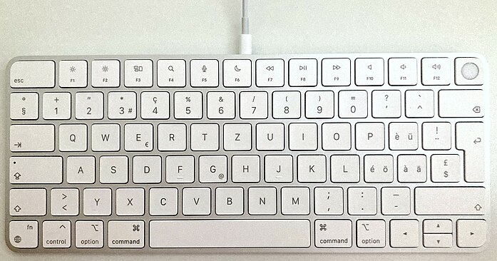 Photo of a Magic Keyboard with Touch ID, swiss keyboard layout, with the Lightning cable connected