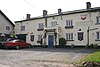 White painted building with pub sign saying The Lamb Inn