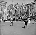 New Orleans, Louisiana, 1943. View on Canal Street, with the D. H. Holmes department store fascade covered with large advertisements urging support for the World War II effort.