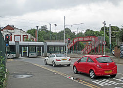 Traffic waiting for a tram to cross