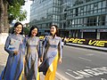 Three girls wearing blue Áo dài are leading each other, 2009