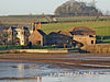 Stone buildings with water in front.