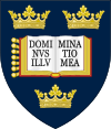 A shield displaying a coat of arms; on a dark blue background, an open book displays the words "Dominus Illuminatio Mea"; two gold crowns above, one below