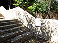 Steps from village to river, with markers of flood levels