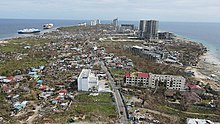 Damage in Punta Engano, Lapu Lapu City. Visible damages to concrete structures, beached ships and downed electric lines. Photo by Bart Sakwerda / Budots Media.