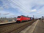 A freight train from DB Cargo Scandinavia passing Trekroner Station.