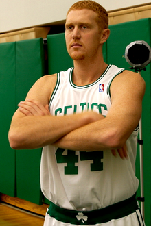 Scalabrine with his arms crossed, wearing a Celtics jersey