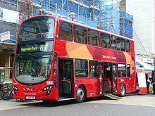 Red London double decked bus with deployed wheelchair ramp