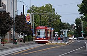 The Portland Streetcar platform at Northeast 7th & Halsey with a streetcar stopped next to it.