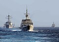 An MH-60S helicopter from USS Freedom approaches RSS Supreme during RIMPAC 2010.