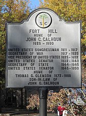 Large cast embossed concrete or metal panel atop a metal post. Embossing gives dates of other senators and politicians as well as Calhoun's son-in-law.