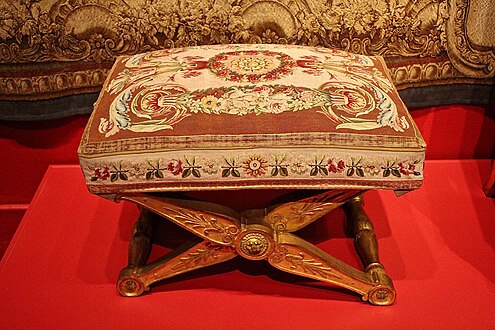 Neoclassical palmettes on a stool, by François-Honoré-Georges Jacob-Desmalter, 1804, carved and gilded wood, and Beauvais tapestry, in a temporary exhibition called Art and Court Life in the Imperial Palace at the Montreal Museum of Fine Arts, Canada