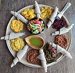 Typical Ethiopian and Eritrean cuisine: Injera (thin pancake-like bread) and several kinds of wat (stew)