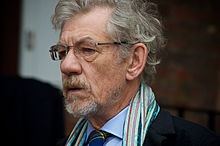 Head shot of Ian McKellen, wearing glasses and a small beard