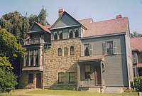 A large three-story house of wood and stone