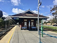 Small brick building on bitumen station platform