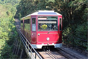 Hong Kong Peak Tramways fifth generation Peak Tram car as viewed from Barker Road, en route to Garden Road Terminus