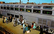 Exterior of silver railcar with large windows