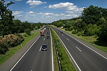 A view of four lane motorway with a central reservation, taken from an elevated point