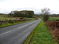 Shennanton. Between two cairns on the B735 road.