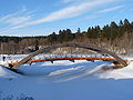 Arch bridge over the frozen Pirita in winter in Kose